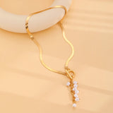 minimalist gold teardrop pearl necklace on model