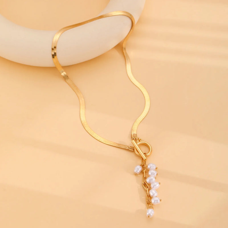 minimalist gold teardrop pearl necklace on model
