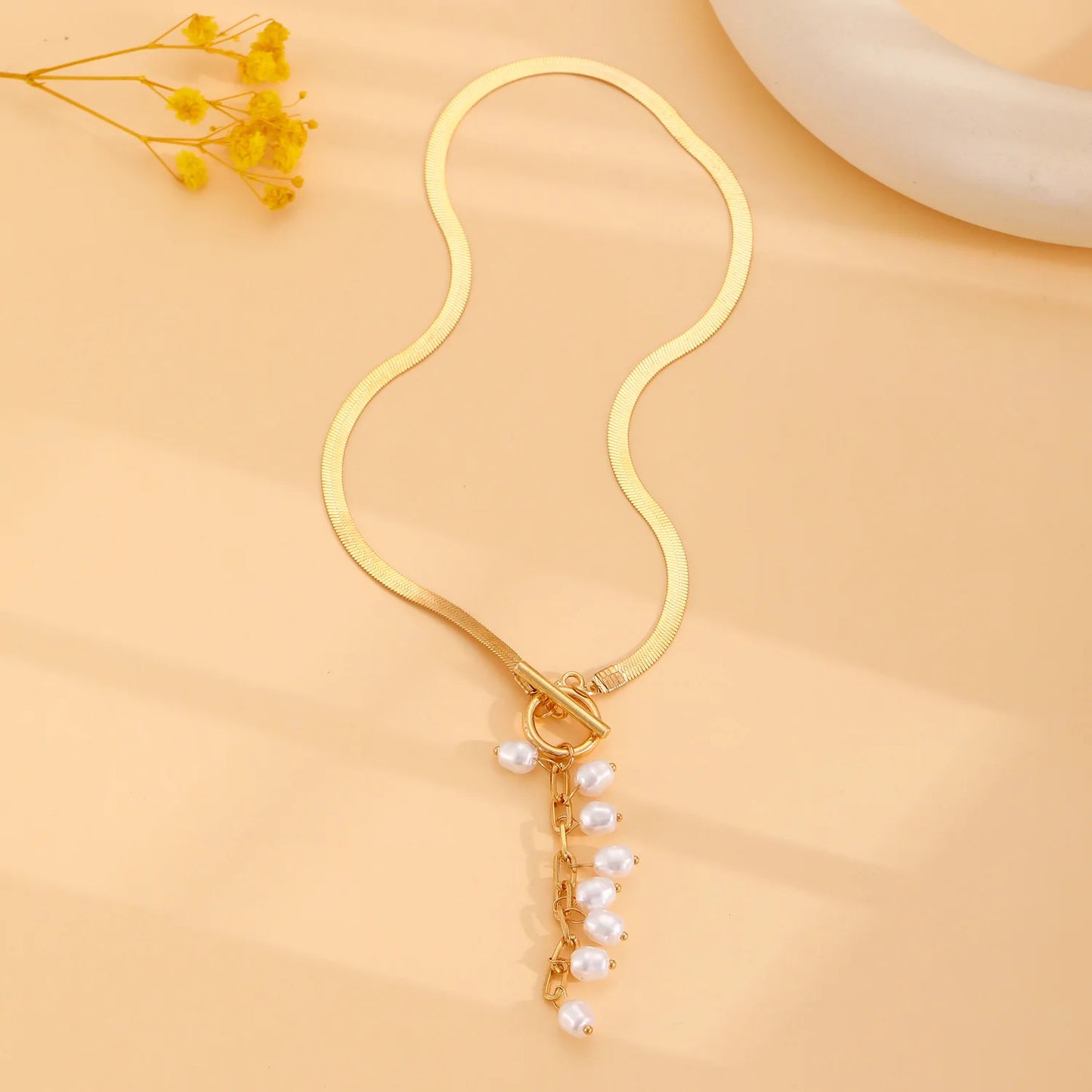 minimalist gold teardrop pearl necklace on model