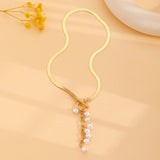 minimalist gold teardrop pearl necklace on model