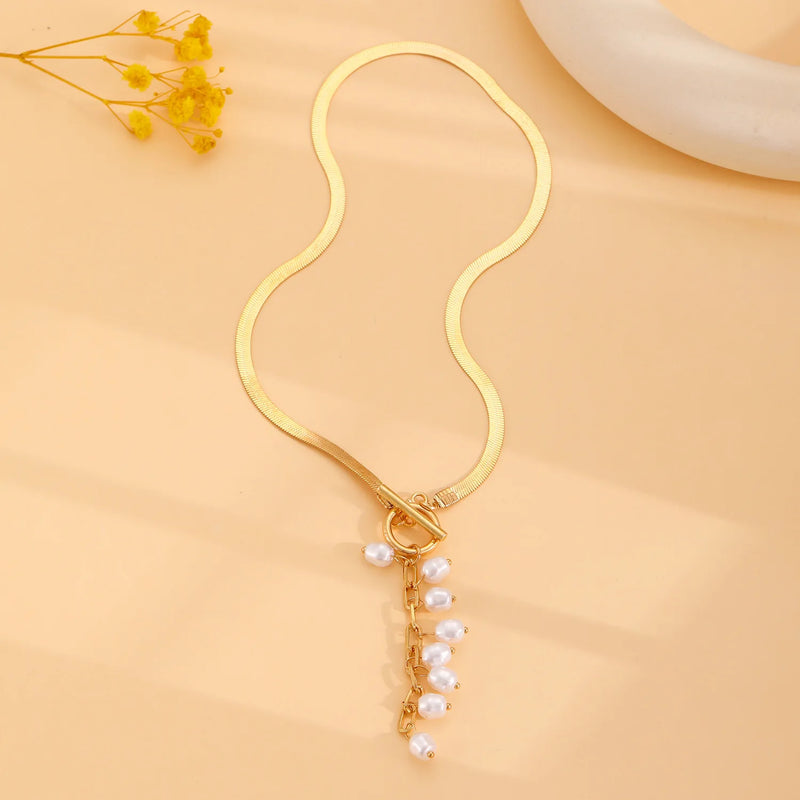 minimalist gold teardrop pearl necklace on model