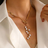 minimalist gold teardrop pearl necklace on model