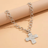 modern industrial cross pendant close-up