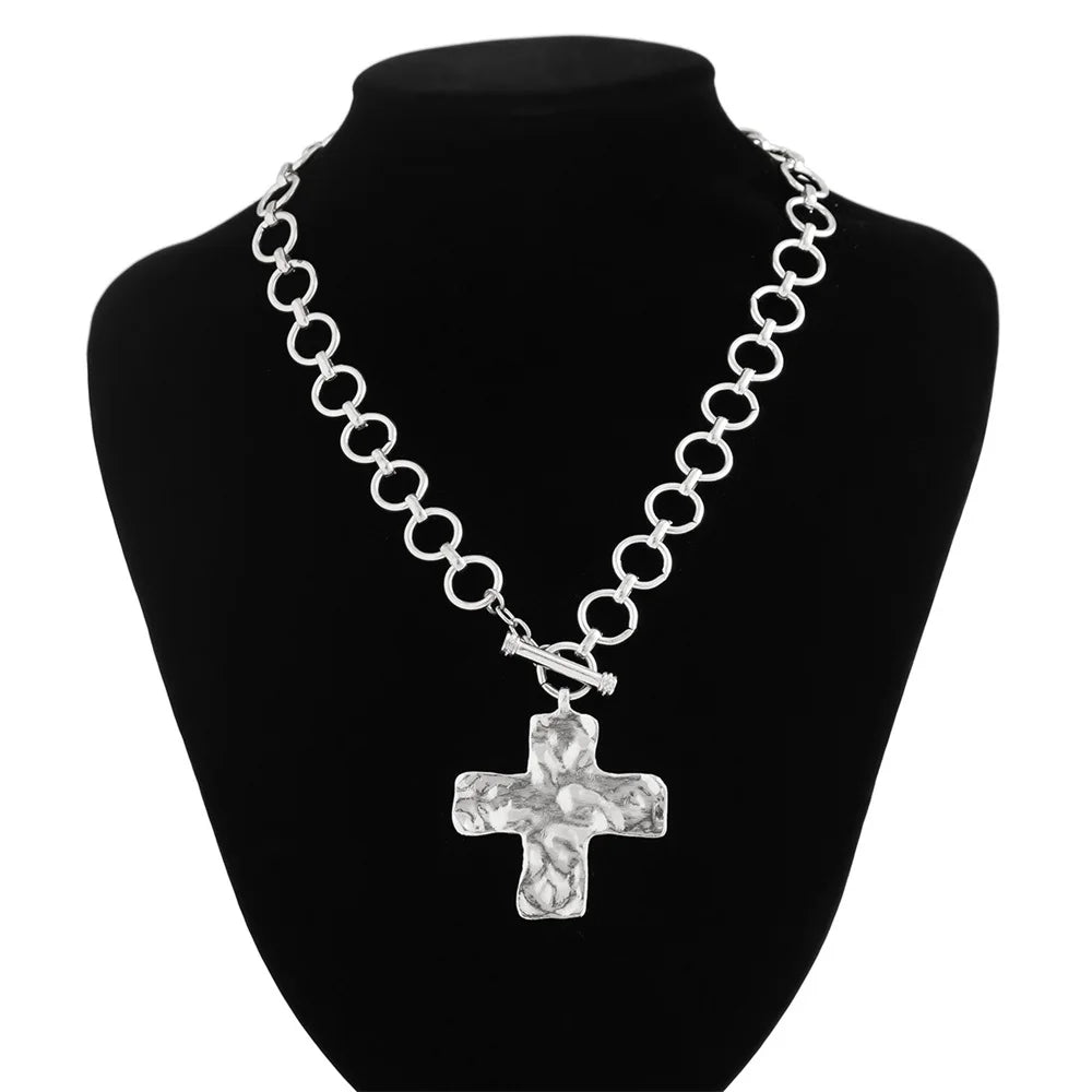 modern industrial cross pendant close-up