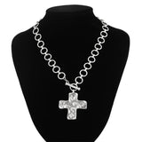 modern industrial cross pendant close-up